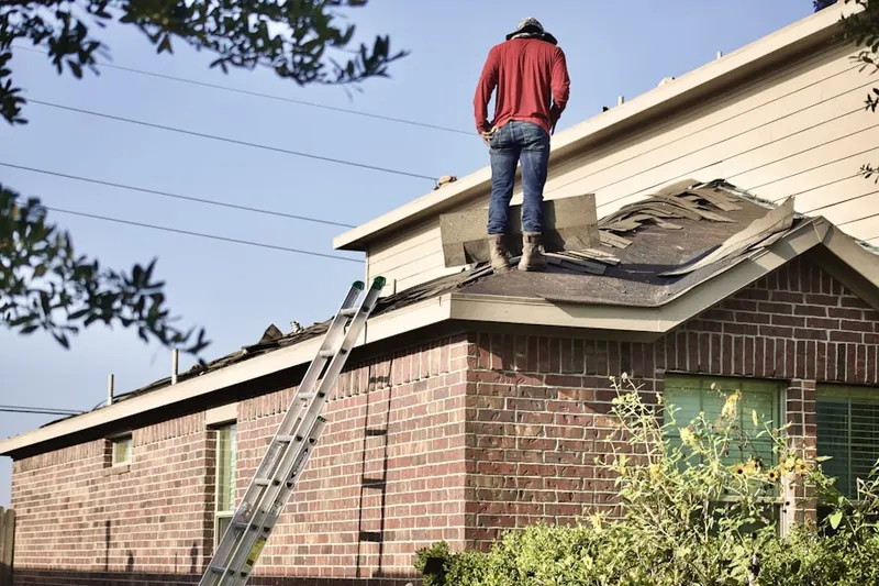 Professional roofer working on a residential roof in The Glen at Greenfields
